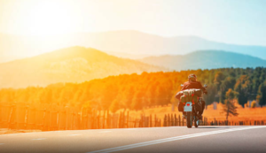 motorcyclist riding through the mountains