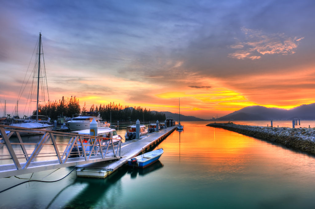 Boats in the dock with a sunset