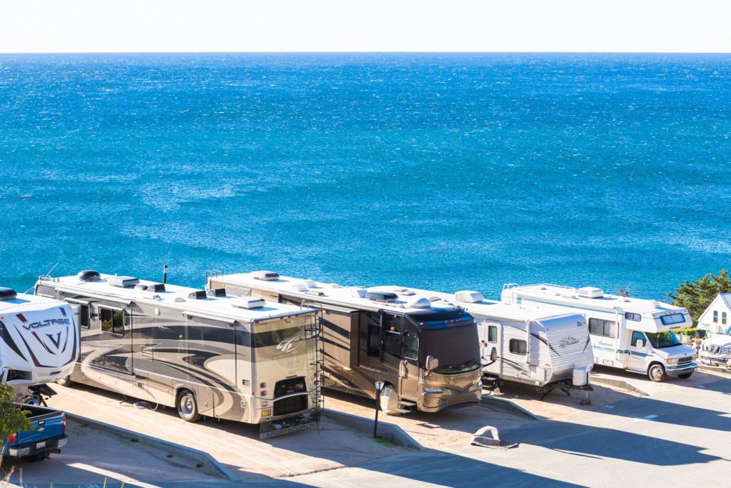 Line of RV's parked by ocean coast